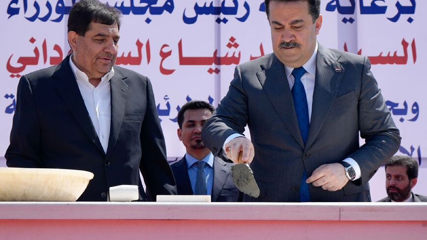Prime Minister Mohammed Shia al-Sudani (R) and Iran's Vice President Mohammad Mokhber lay the foundation stone