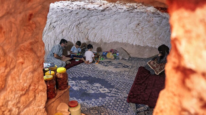 Ahmad Khalil carved out a bomb shelter for his family in the battered Syrian village of Kansafra
