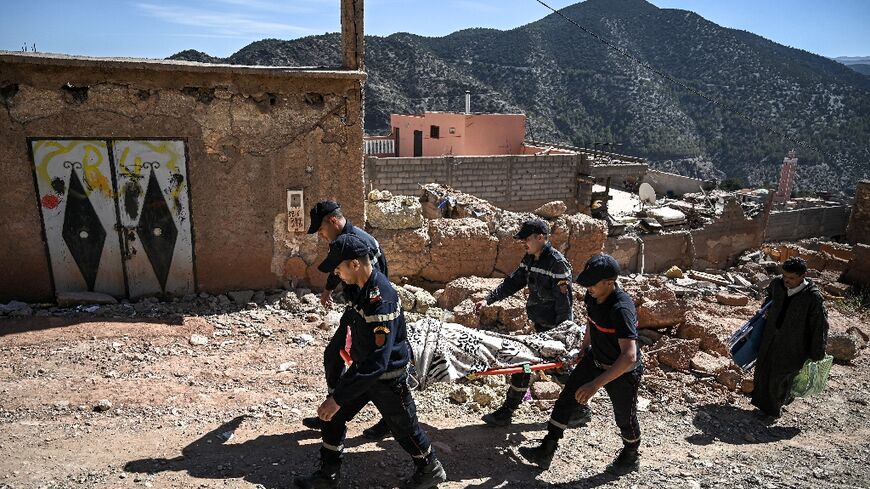 Moroccan civil defence responders evacuate an injured survivor from the village of Moulay Brahim, in Al-Haouz province, the quake epicentre