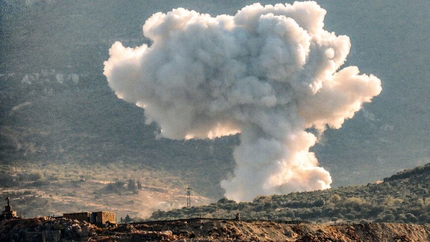 A plume of smoke rises above hills near the city of Jisr ash-Shughur, in rebel-held northwestern Idlib during bombardment by pro-Syrian forces 