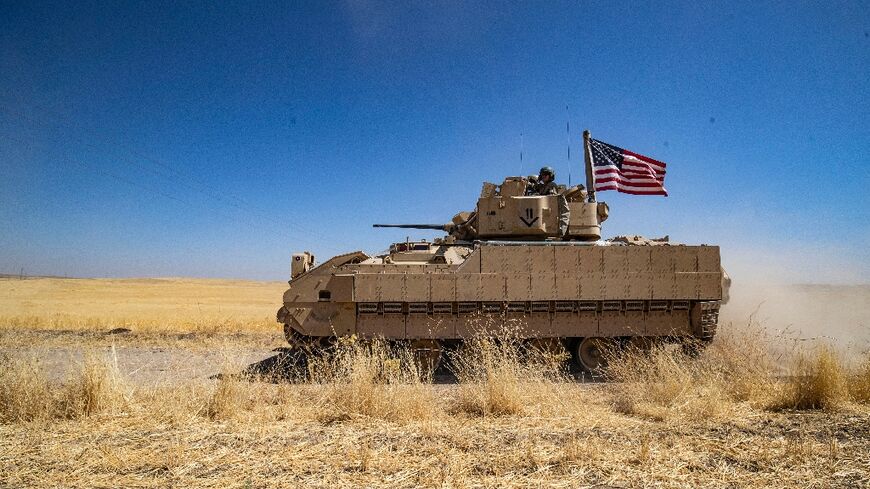 US soldiers in a Bradley Fighting Vehicle (BFV) patrol the countryside of al-Malikiya town (Derik in Kurdish) in Syria's northeastern Hasakeh province July 17, 2023