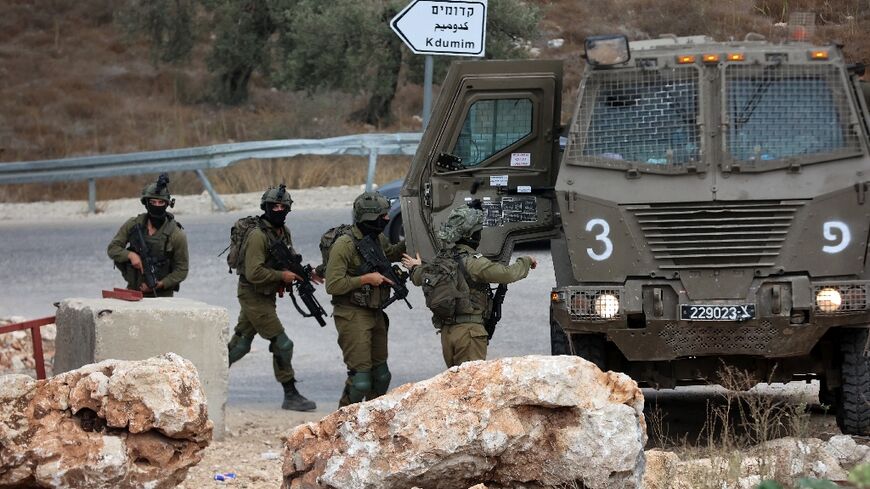 Israeli soldiers patrol near the West Bank city of Tulkarm where two Palestinians were reportedly killed during clashes with Israeli forces 