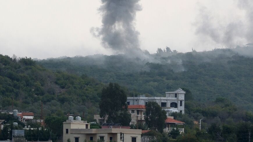 Smoke billows following Israeli artillery bombing on the outskirts of the southern Lebanese border village of Aita al-Shaab
