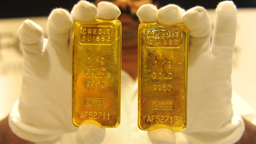 A jewelry shop employee displays 24-carat gold bars in Ahmedabad, August 20, 2011.