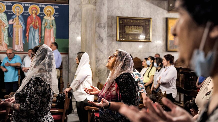 Palestinian Greek Orthodox Christians pray during Sunday Mass at the Church of Saint Porphyrius in Gaza City, on May 30, 2021. 