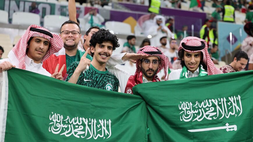 Fans of Saudi Arabia pose with national flags on the stands ahead of the Qatar 2022 World Cup Group C football match between Saudi Arabia and Mexico at the Lusail Stadium in Lusail, north of Doha on Nov. 30, 2022. 