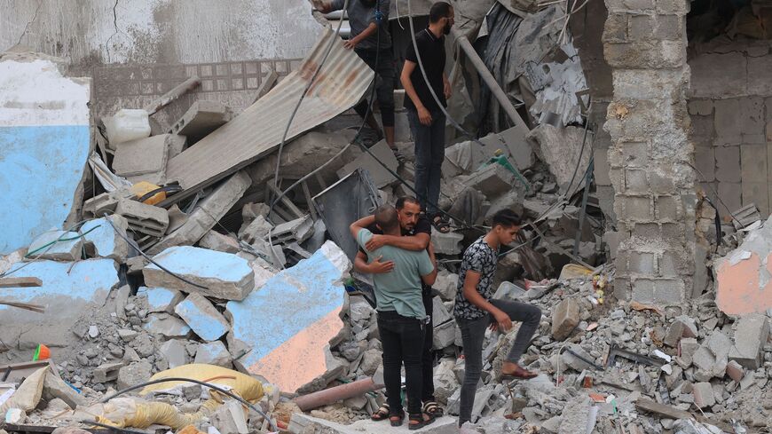 Palestinians look for survivors under the rubble of a house destroyed by an Israeli air strike in Rafah.