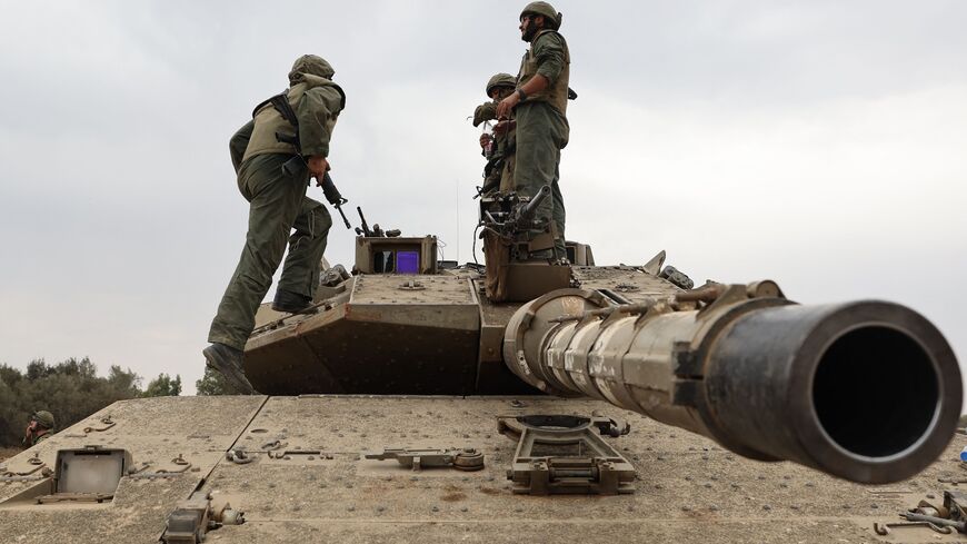 Israeli army soldiers are positioned with their Merkava tanks near the border with the Gaza Strip in southern Israel, Oct. 9, 2023