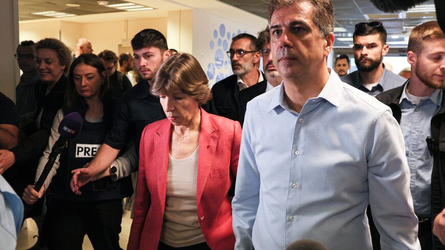 French Foreign Minister Catherine Colonna (C) and Israeli Foreign Minister Eli Cohen (R) visit the damaged Barzilai Medical Center in the city of Ashkelon on October 15, 2023, amid the ongoing battles between Israel and the Palestinian Islamist group Hamas. Hamas launched a large-scale attack on Israel on October 7 which killed at least 1300 people, sparking a retaliatory bombing campaign that has killed more than 1900 in the Gaza Strip ahead of a potential Israeli ground invasion of the territory. (Photo b