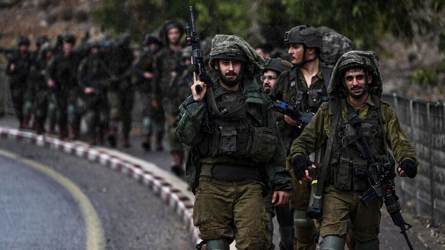 Israeli army soldiers patrol an undisclosed area in northern Israel bordering Lebanon on Oct. 15, 2023.