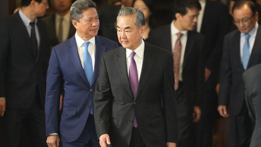 Chinese Foreign Minister Wang Yi (C) arrives at the opening ceremony of diplomatic symposium at the Diaoyutai State Guesthouse in Beijing on October 24, 2023. (Photo by Ken Ishii / POOL / AFP) (Photo by KEN ISHII/POOL/AFP via Getty Images)