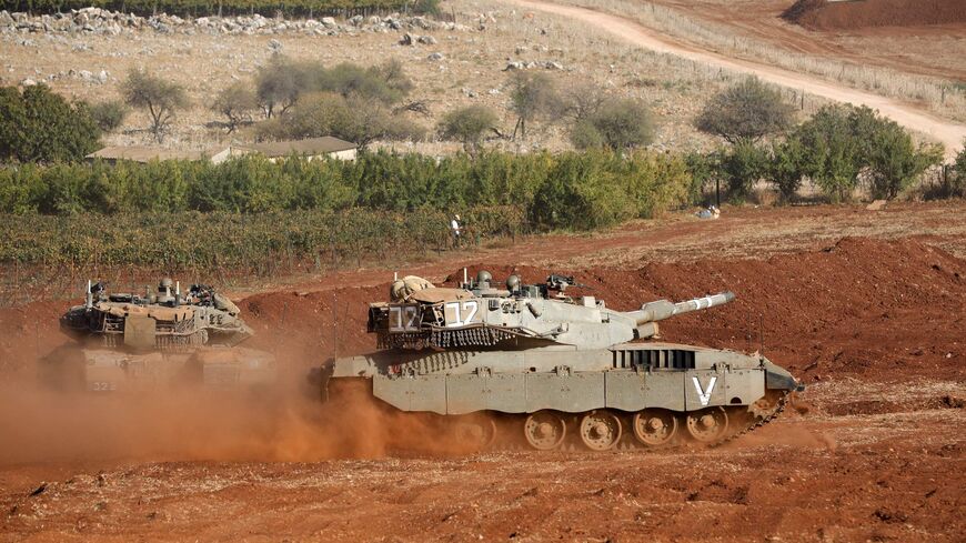 Israeli Merkava tanks take part in a military drill near the border with Lebanon in the upper Galilee region of northern Israel on Oct. 26, 2023, amid the ongoing battles between Israel and the Palestinian group Hamas in the Gaza Strip. 