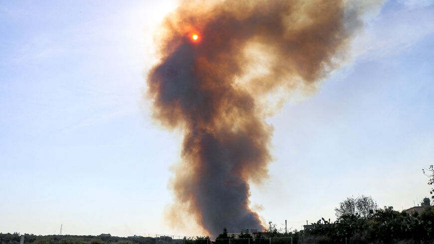 A smoke plume covers the sun during a forest fire that reportedly ignited after shell fire from Israel, in the Labouneh area in southern Lebanon close to the border with northern Israel, on October 26, 2023, amid the ongoing battles between Israel and the Palestinian group Hamas in the Gaza Strip. (Photo by AFP) (Photo by -/AFP via Getty Images)
