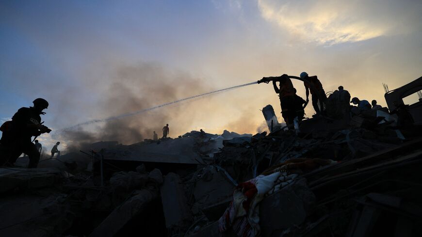 Palestinians search for survivors in the rubble of a building in the Nuseirat refugee camp, in the central Gaza Strip on October 31, 2023, amid relentless Israeli bombardment of the Palestinian enclave. Thousands of civilians, both Palestinians and Israelis, have died since October 7, 2023, after Palestinian Hamas militants based in the Gaza Strip entered southern Israel in an unprecedented attack triggering a war declared by Israel on Hamas with retaliatory bombings on Gaza. (Photo by Mahmud HAMS / AFP) (P