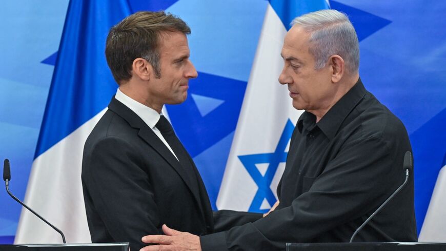 Macron shakes hands with Netanyahu