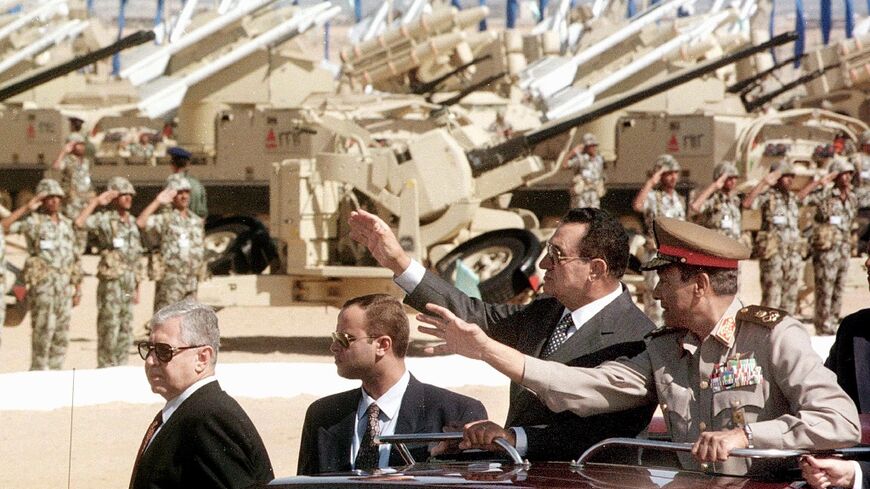 Hosni Mubarak (2nd-R) reviews Egyptian soldiers during a military parade on the 25th anniversary of the 1973 Arab-Israeli war
