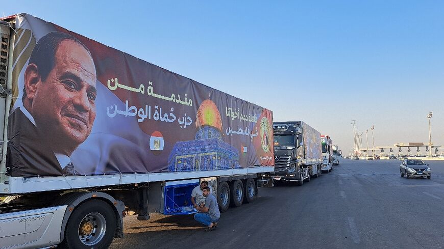 A convoy of trucks is waiting to go into Gaza on the Egyptian side of the border 