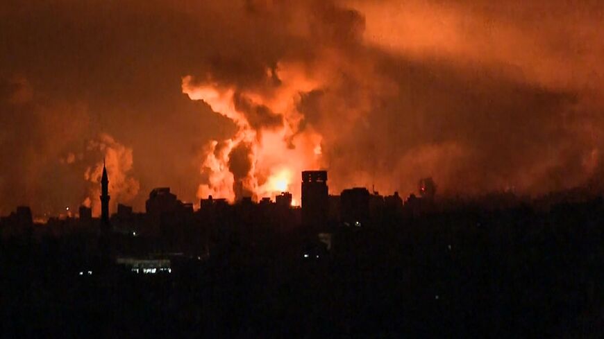 A grab from AFP TV shows fireballs in Gaza City during Israeli strikes