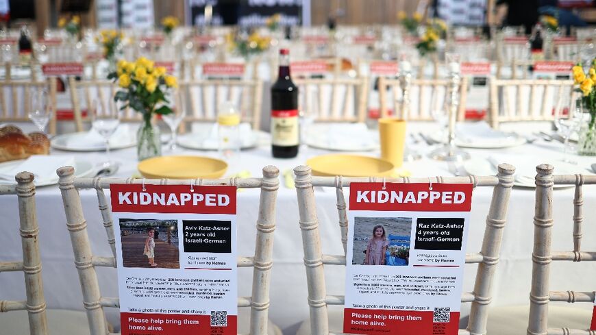 Around a huge table were more than 200 empty seats with the name, age and nationality of the captives