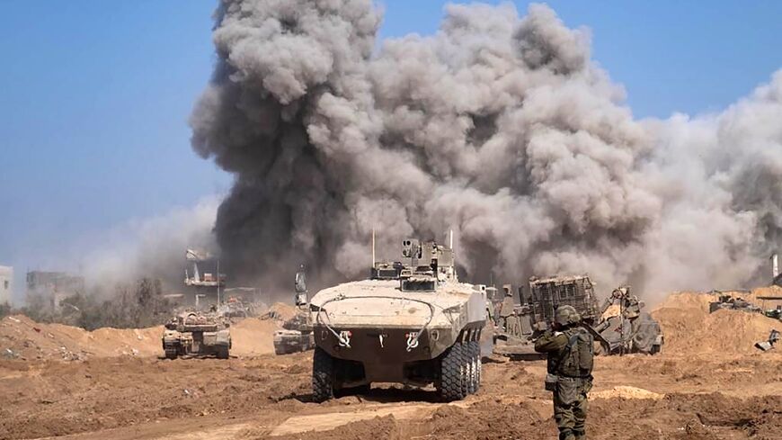 A picture released by the Israeli army on November 5, 2023 shows Israel military vehicles and heavy smoke inside the Gaza Strip as battles between Israel and the Palestinian Hamas movement continue