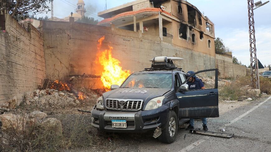 Flames near a press car in Lebanon's southern border village of Yarun