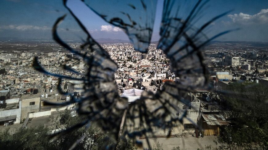 Jenin city, seen beyond a bullet hole in the window through which Mohammed Sabbagh was shot