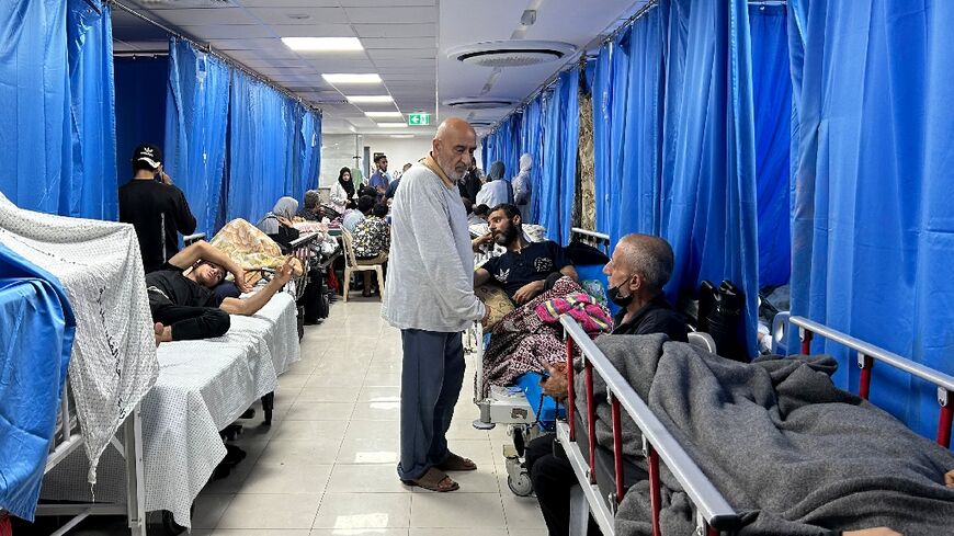 Patients and internally displaced line the halls at Al-Shifa hospital in Gaza City 