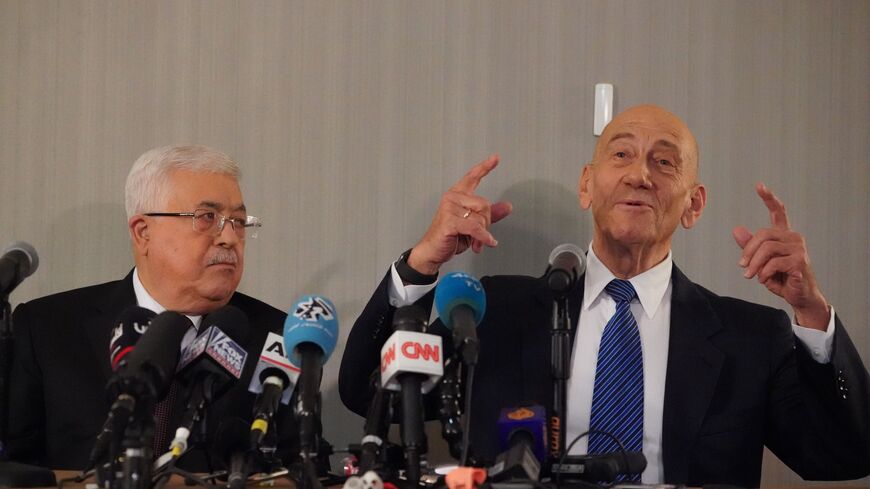 Palestinian president Mahmud Abbas (L) and Former Israeli Prime Minister, Ehud Olmert hold a briefing on US President Donald Trump's Mideast plan on February 11, 2020 in New York. - Palestinian president Mahmud Abbas told the UN Security Council that the world should reject President Donald Trump's Middle East plan, which he said would limit Palestinian sovereignty in a "Swiss cheese" deal. "We reject the Israeli-American plan," which "throws into question the legitimate rights of the Palestinians," Abbas s