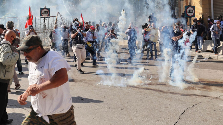 Tear gas canisters are fired among journalists and demonstrators during a protest demanding better pay and living conditions. Beirut, Lebanon, April 18, 2023.