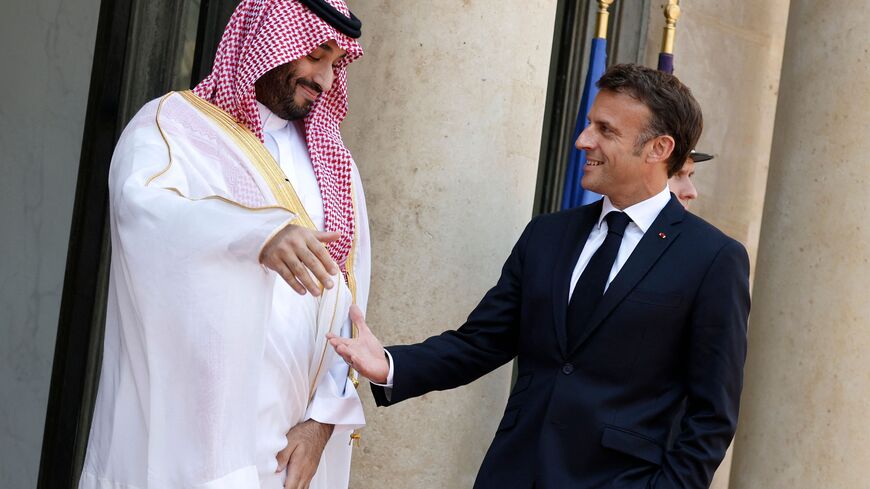 TOPSHOT - France's President Emmanuel Macron greets Saudi Crown Prince Mohammed bin Salman as he arrives at presidential Elysee Palace in Paris, on June 16, 2023. French President Emmanuel Macron hosts Saudi Arabia's Crown Prince Mohammed bin Salman for talks in Paris, seeking to nudge the de-facto leader of the oil-rich kingdom into more full-throated support of Ukraine against the Russian invasion. (Photo by Ludovic MARIN / AFP) (Photo by LUDOVIC MARIN/AFP via Getty Images)
