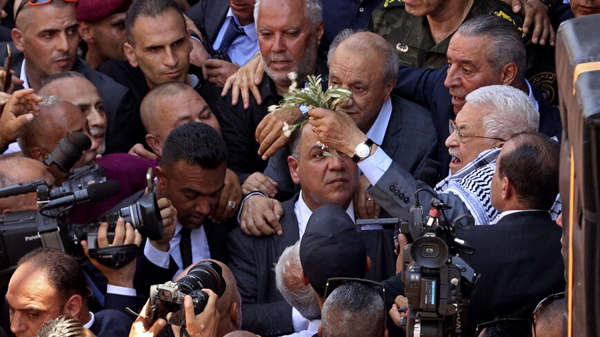 TOPSHOT - Palestinian president Mahmud Abbas (R) arrives to lay a wreath of flowers by the graves of Palestinians killed in recent Israeli military raids on the Jenin camp for Palestinian refugees, north of the occupied West Bank on July 12, 2023. (Photo by Zain JAAFAR / AFP) (Photo by ZAIN JAAFAR/AFP via Getty Images)