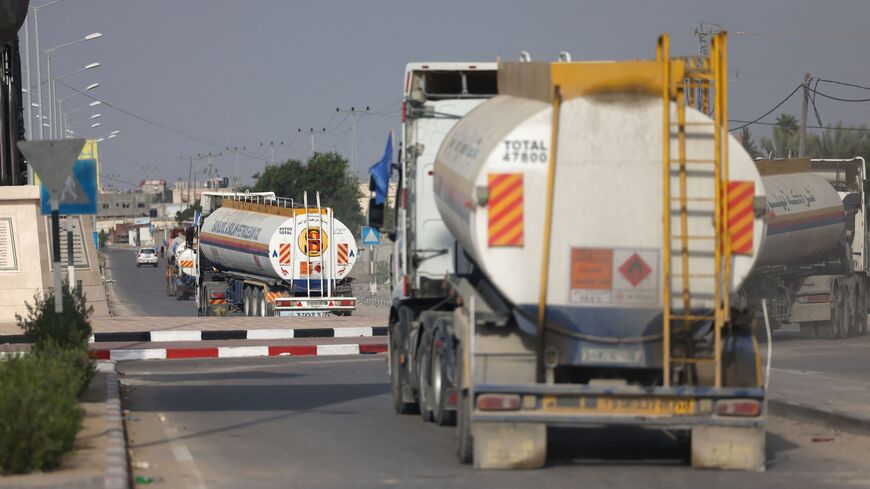 Trucks carrying fuel enter the Gaza Strip through the Rafah crossing with Egypt, Oct. 22, 2023.