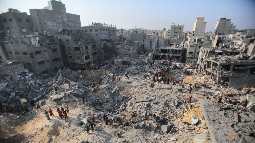 Palestinians amid the destruction following an Israeli strike in the Jabalia refugee camp, Gaza Strip, Nov. 1, 2023.