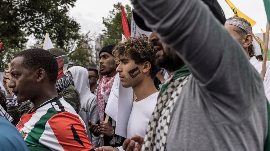Pro-Palestinian supporters pray while gathering during an anti US and anti Israel demonstration in front of the US Consulate in Johannesburg, on November 04, 2023.