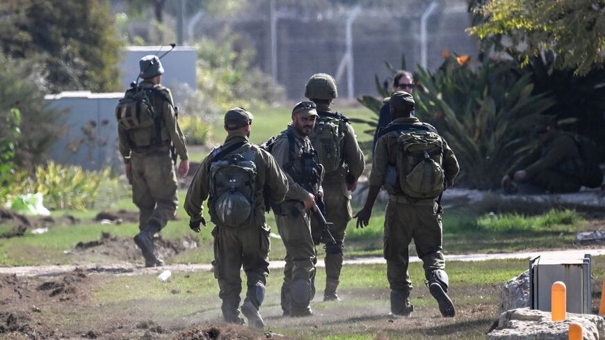 Israeli soldiers patrol in Kibbutz Beeri in southern Israel on November 5, 2023, nearly a month after the October 7 attack by Palestinian militants that left more that 1400 Isaelis dead. The printing press in Beeri, an Israeli community that suffered one of Hamas's worst atrocities on October 7, has started up again in a small step towards recovery. (Photo by Aris MESSINIS / AFP