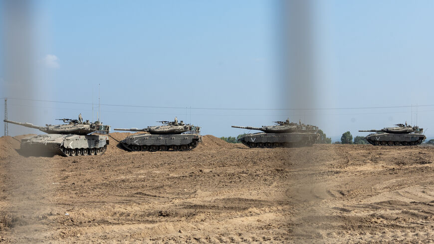 SOUTHERN ISRAEL - NOVEMBER 01: Tanks move across a field on November 01, 2023 in Southern Israel. As Israel's response to Hamas's Oct 7 attacks entered its fourth week, the Israeli PM said the current war would be a long one and would amount to a "second war of independence." In the wake Hamas's attacks that left 1,400 dead and 230 kidnapped, Israel launched a sustained bombardment of the Gaza Strip and began a ground invasion to vanquish the militant group that governs the Palestinian territory. (Photo by 