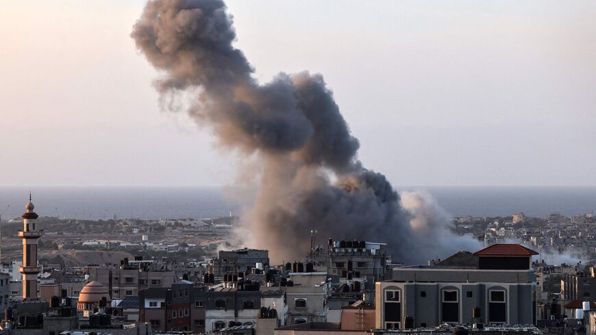 A plume of smoke rises over Rafah in the southern Gaza Strip during an Israeli strike on Nov. 9, 2023, amid ongoing battles between Israel and the Palestinian Hamas movement.