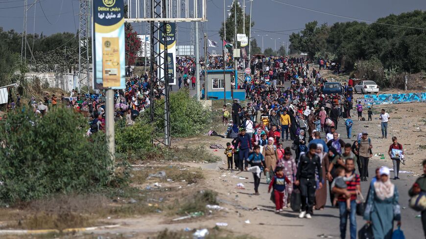 Palestinians families fleeing Gaza City and other parts of northern Gaza towards the southern areas, walk along a highway on Nov. 9, 2023, amid the ongoing battles between Israel and the Palestinian Islamist group Hamas. 