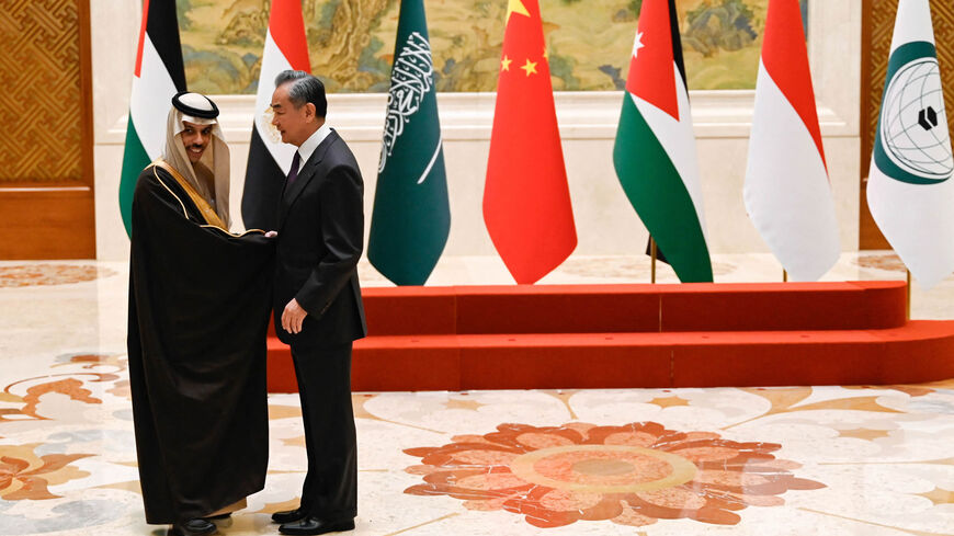 China's Foreign Minister Wang Yi (R) shakes hands with Saudi Arabia's Foreign Minister Prince Faisal bin Farhan Al Saud before a family photo for the attendees of a meeting of foreign ministers from Arab and Muslim-majority nations at the Diaoyutai State Guest House, Beijing, China, Nov. 20, 2023.