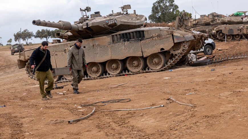 Members of the Israeli Defense Forces (IDF) work at a staging area near the border of Gaza as a four day cease fire between Israel and members of Hamas holds for the release of prisoners and hostages on Nov. 27, 2023 outside of the city of Sedero in Tel Aviv, Israel. 