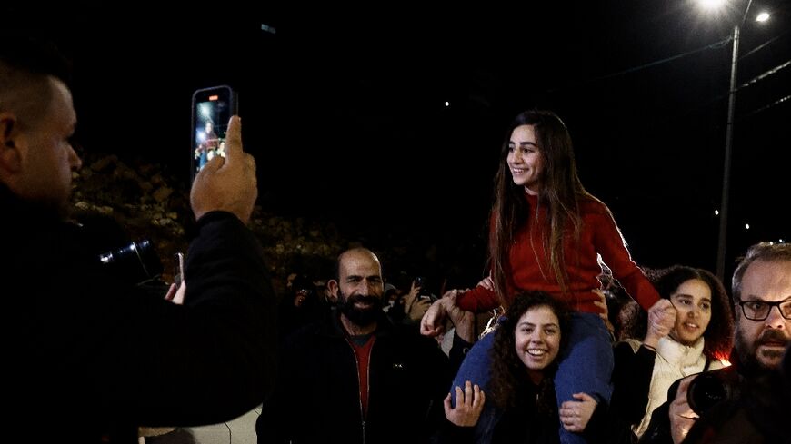 Rouba Assi is carried by supporters in the West Bank city of Ramallah after her release from an Israeli prison as part of an exchange for hostages held by Hamas in the Gaza Strip