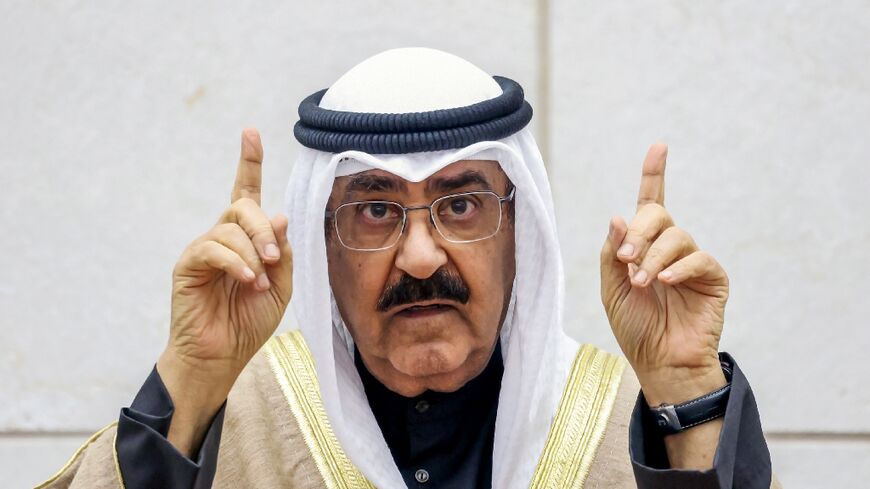 Kuwait's new emir Sheikh Meshal al-Ahmad al-Sabah gestures as he swears in before lawmakers as the country's 17th ruler