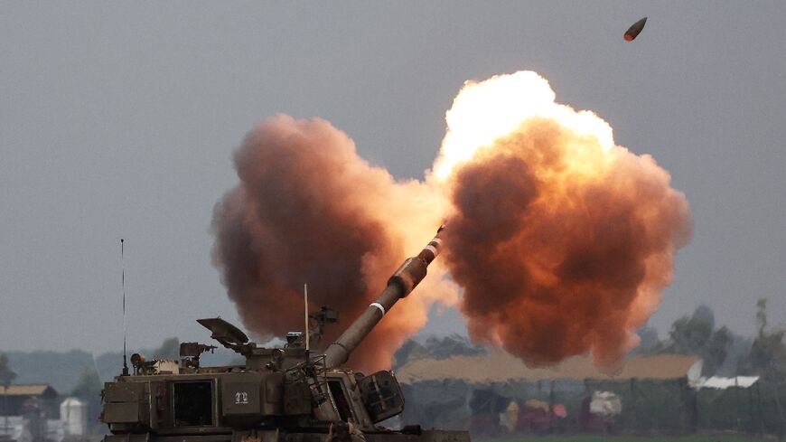 An Israeli army tank shells the Gaza Strip from the border area in southern Israel