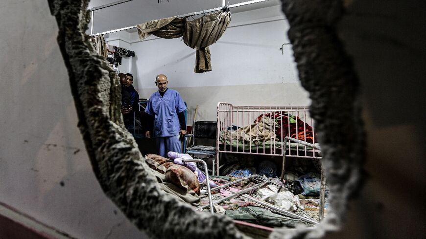 People inspect bombing damage at Nasser hospital in Khan Yunis in the southern Gaza Strip on December 17, 2023