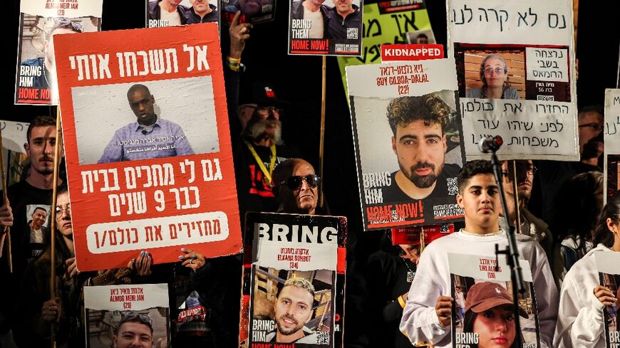Protesters in Tel Aviv show portraits of Israeli hostages on December 9