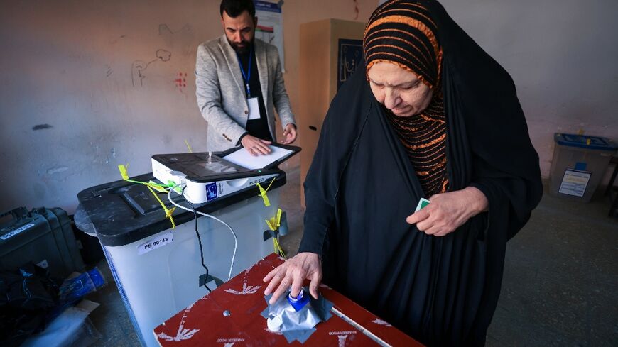 A woman votes in Baghdad in Iraq's first provincial council elections in a decade