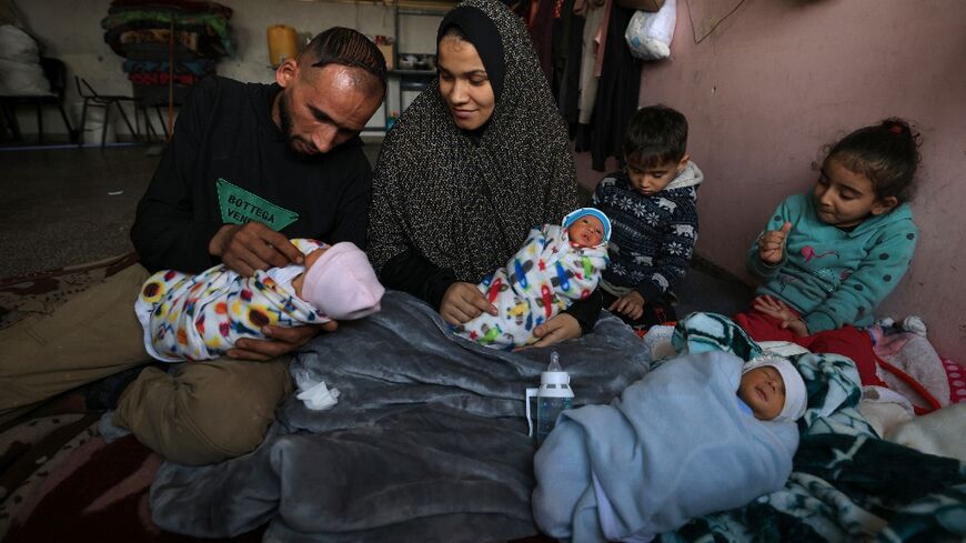 Displaced by war in Gaza Iman al-Masry is surrounded by her husband Ammar and her children including three of four babies born prematurely in the south of the war-devastated territory