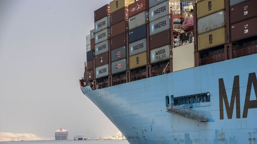 A Maersk container ship sails through the new section of the Suez Canal.