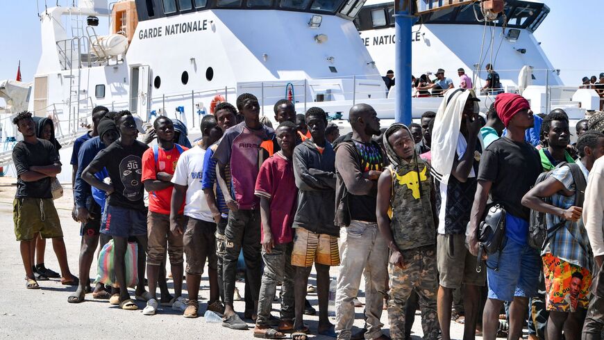 Migrants of African origin trying to flee to Europe, disembark in Sfax from a ship owned by the Tunisian coast guards, after being intercepted by them at sea on August 10, 2023. 