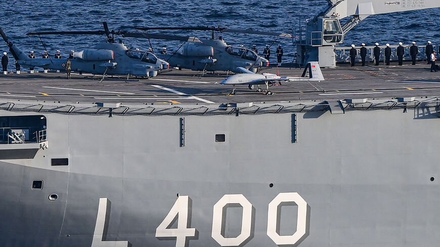 This photo taken on October 29, 2023 in Istanbul shows a Bayraktar TB-2 drone and helicopters on the Turkish navy's L-400 Anadolu warship, during a naval military parade on the Bosphorus to mark the 100th anniversary of the Turkish Republic. (Photo by Ozan KOSE / AFP) (Photo by OZAN KOSE/AFP via Getty Images)